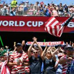 Fans in USA gear cheer at a FIFA World Cup match